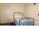 Cozy bedroom with an iron bed frame and hardwood floors at 229 W Park Ave, Mooresville, NC 28115