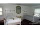 Bright bedroom with twin beds, vintage brass accents, and natural light from large windows at 229 W Park Ave, Mooresville, NC 28115