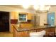 Charming kitchen featuring ample counter space, light wood cabinets, and a stainless steel refrigerator at 229 W Park Ave, Mooresville, NC 28115