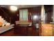 Spacious living room featuring wood paneled walls, hardwood floors, and comfortable seating at 229 W Park Ave, Mooresville, NC 28115