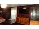 Cozy living room featuring wood-paneled walls, hardwood floors, and built-in cabinetry at 229 W Park Ave, Mooresville, NC 28115