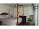Spacious bedroom with a four-poster bed, fireplace, and natural light at 229 W Park Ave, Mooresville, NC 28115