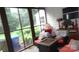 Relaxing enclosed porch featuring comfortable seating and view of the surrounding greenery at 229 W Park Ave, Mooresville, NC 28115