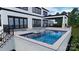 Inviting pool with water feature and hot tub, surrounded by lush landscaping at 268 Hermance Ln, Mooresville, NC 28117