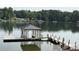 Picturesque covered boat dock on a serene lake surrounded by lush greenery at 268 Hermance Ln, Mooresville, NC 28117