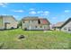 Fenced backyard with a grass lawn and view of the home's exterior at 2706 Stagbuck Dr, Gastonia, NC 28052