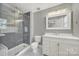Remodeled bathroom with white vanity, tile floor and glass enclosed shower at 2706 Stagbuck Dr, Gastonia, NC 28052