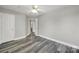 Bedroom with grey wood-look floors, ceiling fan, and closet at 2706 Stagbuck Dr, Gastonia, NC 28052