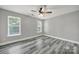 Clean bedroom with grey wood-look floors and two windows at 2706 Stagbuck Dr, Gastonia, NC 28052