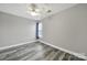 Bedroom with grey wood-look floors, ceiling fan and one window at 2706 Stagbuck Dr, Gastonia, NC 28052