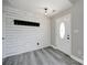 A modern entryway features shiplap walls, a coat rack, and stylish gray laminate flooring at 2706 Stagbuck Dr, Gastonia, NC 28052