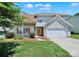 Charming home with an orange front door, a white garage door, and a cozy front porch at 2706 Stagbuck Dr, Gastonia, NC 28052