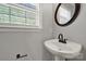 Bathroom with grey walls, a white pedestal sink and a brown mirror at 2706 Stagbuck Dr, Gastonia, NC 28052