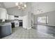 A kitchen with tile floors is adjacent to a living room with high ceilings and a ceiling fan at 2706 Stagbuck Dr, Gastonia, NC 28052
