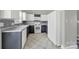 A well-lit kitchen features a white dishwasher, a white stove, two-tone cabinets, and decorative backsplash at 2706 Stagbuck Dr, Gastonia, NC 28052