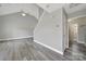 An open living space features a high vaulted ceiling, a ceiling fan, gray flooring, and a staircase at 2706 Stagbuck Dr, Gastonia, NC 28052
