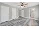 Bedroom with grey wood-look floors, ceiling fan, and attached bathroom at 2706 Stagbuck Dr, Gastonia, NC 28052