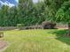 Expansive backyard with lush green grass, mature trees, and a charming fence at 2927 Dubberly Ct, Matthews, NC 28105