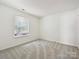 Cozy bedroom features neutral carpeting and a window providing ample natural light at 2927 Dubberly Ct, Matthews, NC 28105