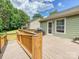 Large wooden deck with railing, offering an outdoor space for dining and relaxing with lush greenery in the background at 2927 Dubberly Ct, Matthews, NC 28105