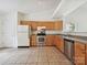 Bright kitchen with tile floors, wood cabinets, stainless steel appliances, and plenty of counter space at 2927 Dubberly Ct, Matthews, NC 28105