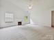 Bright living room with vaulted ceilings, plush carpeting, and a cozy fireplace at 2927 Dubberly Ct, Matthews, NC 28105