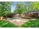 Outdoor space with wooden deck, gravel area, and mature trees at 2953 Enfield Rd, Charlotte, NC 28205