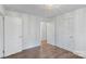 Neutral bedroom with hardwood floors, beadboard walls, and lots of doors at 2953 Enfield Rd, Charlotte, NC 28205