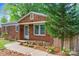 Attractive brick home with manicured flower beds and walkway leading to the front door at 2953 Enfield Rd, Charlotte, NC 28205