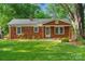 Charming brick home with a well-maintained lawn and mature trees in a desirable neighborhood at 2953 Enfield Rd, Charlotte, NC 28205