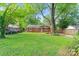 Exterior view of the brick home, showing the large front lawn and mature trees at 2953 Enfield Rd, Charlotte, NC 28205