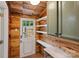 Mud room with shelving, wood paneling, and an exterior door at 2953 Enfield Rd, Charlotte, NC 28205