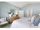 Comfortable primary bedroom with dresser and chair, large window with curtains, and soft neutral tones at 3019 Sassafrass Trl, Gastonia, NC 28056