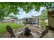 Lakeside backyard with seating around a fire pit, views of the lake, and mature shade trees at 307 Lake Head Rd, Norwood, NC 28128