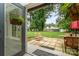 A charming backyard patio featuring outdoor seating, lush green grass, and views of the waterfront at 307 Lake Head Rd, Norwood, NC 28128