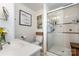 Bathroom featuring a walk-in shower, modern vanity, decorative mirror and artwork at 307 Lake Head Rd, Norwood, NC 28128