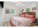 Bedroom features a wicker headboard, floral bedding, and ample natural light from the windows at 307 Lake Head Rd, Norwood, NC 28128