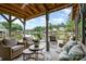 Relaxing outdoor sitting area with comfortable furniture under covered dock with views of lake at 307 Lake Head Rd, Norwood, NC 28128