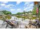 A waterfront view from a private dock, featuring comfortable lounge chairs and scenic lake views under a partly cloudy blue sky at 307 Lake Head Rd, Norwood, NC 28128