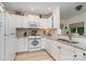 A bright kitchen with white cabinets, modern appliances, granite countertops, and stylish backsplash at 307 Lake Head Rd, Norwood, NC 28128
