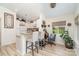 Eat-in kitchen area features barstool seating, white cabinetry, and an adjacent home office nook at 307 Lake Head Rd, Norwood, NC 28128