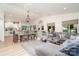 Open-concept living and dining area featuring hardwood floors, white walls, a decorative chandelier and large windows at 307 Lake Head Rd, Norwood, NC 28128