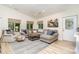 A cozy living room featuring a sectional sofa, area rug, and natural light from the windows at 307 Lake Head Rd, Norwood, NC 28128