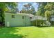 Back exterior of the house with a deck overlooking the large, green backyard at 3331 Eastwood Dr, Charlotte, NC 28205