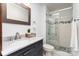 Stylish bathroom featuring a gray vanity, marble countertop, and a modern glass-enclosed shower at 3331 Eastwood Dr, Charlotte, NC 28205