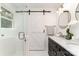 This bathroom features double sinks, modern vanity, and a sliding barn door at 3331 Eastwood Dr, Charlotte, NC 28205