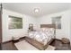 Cozy bedroom with hardwood floors, natural light, and a bed with a floral comforter at 3331 Eastwood Dr, Charlotte, NC 28205