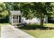 Charming home featuring a welcoming front porch, gray siding, and a well-manicured lawn at 3331 Eastwood Dr, Charlotte, NC 28205
