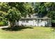 Charming single-story home featuring a well-maintained lawn, light gray siding, and a tree providing shade at 3331 Eastwood Dr, Charlotte, NC 28205