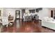 Open concept kitchen and dining area with hardwood floors, gray cabinets, and an island with barstools at 3331 Eastwood Dr, Charlotte, NC 28205